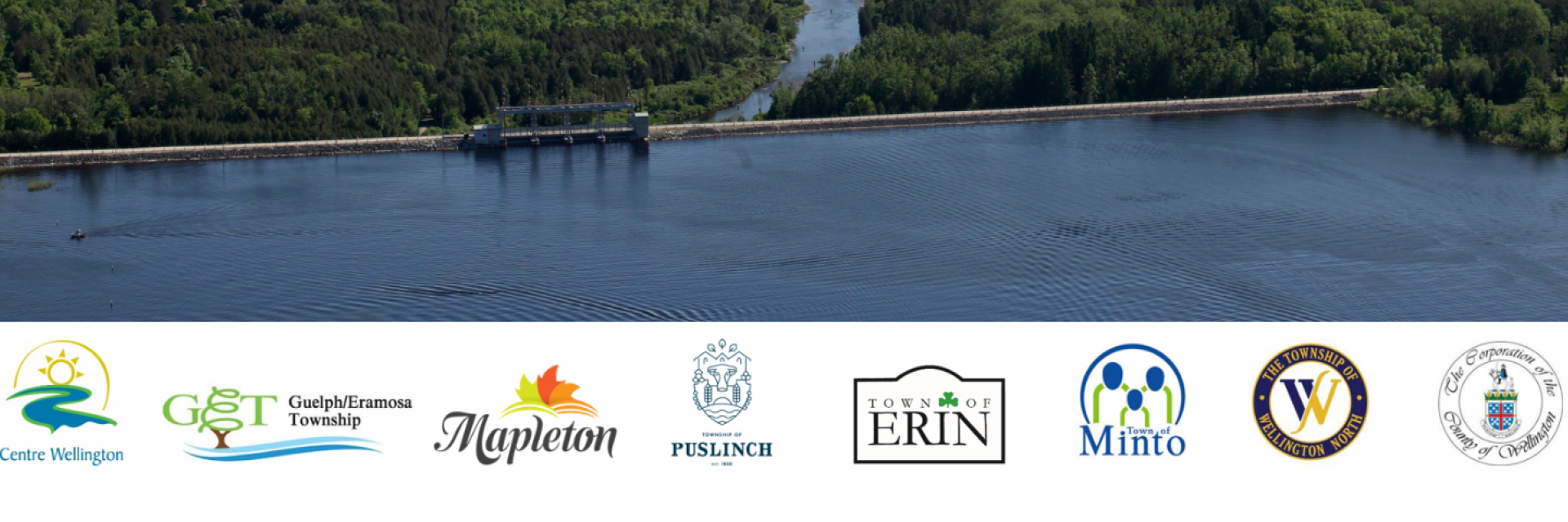 A reservoir and dam surrounded by forest. Includes logos of Centre Wellington, Guelph/Eramosa, Mapleton, Puslinch, Erin, Minto, Wellington North, and Wellington County.
